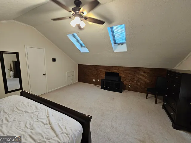 a bed room with a bed and a ceiling fan