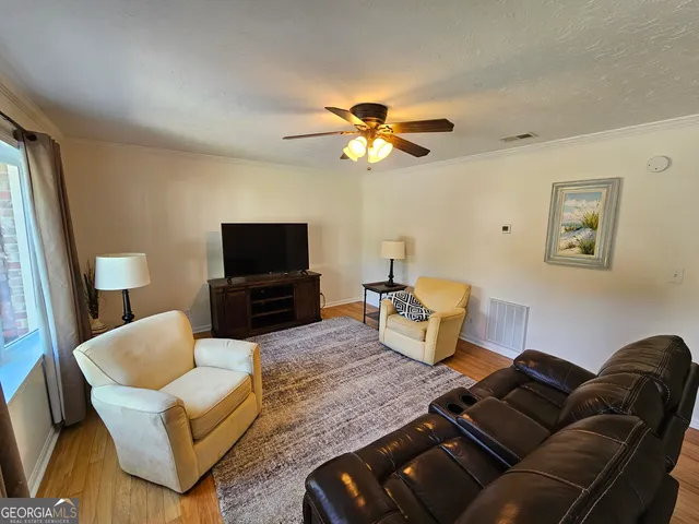 a living room with furniture and a flat screen tv