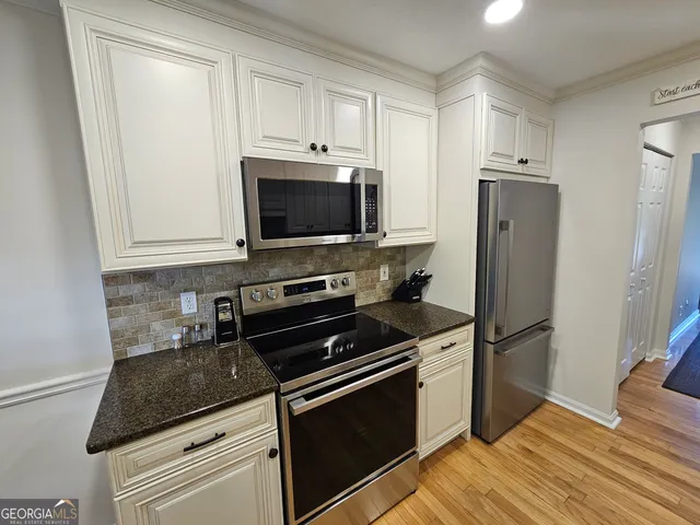 a kitchen with a refrigerator stove and microwave