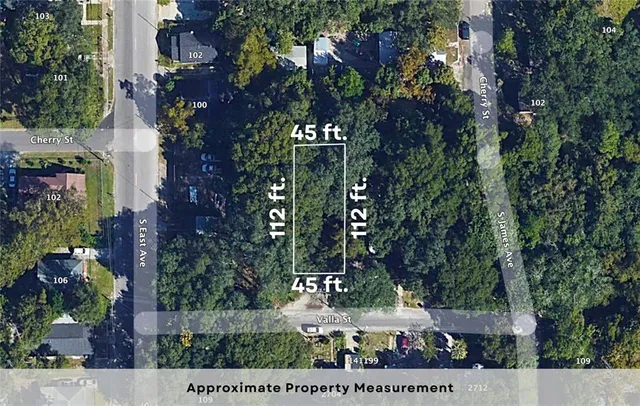 front view of multi story residential apartment building with yard