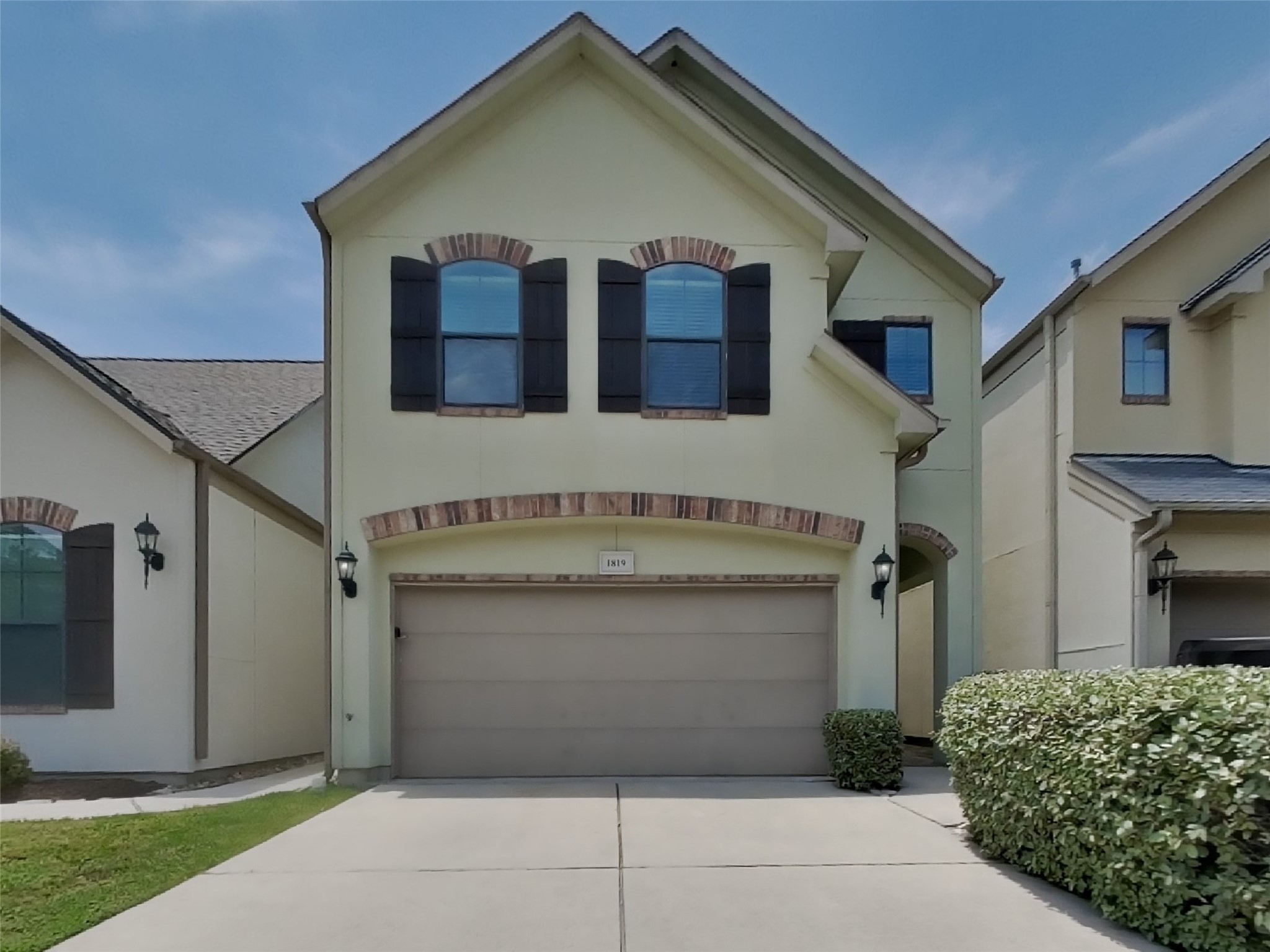 a front view of a house with garage