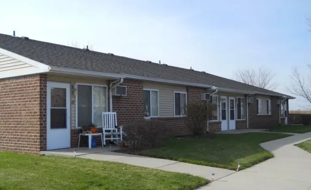 a view of a house with a yard and sitting area
