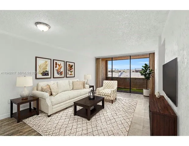 a living room with furniture wooden floor and a flat screen tv