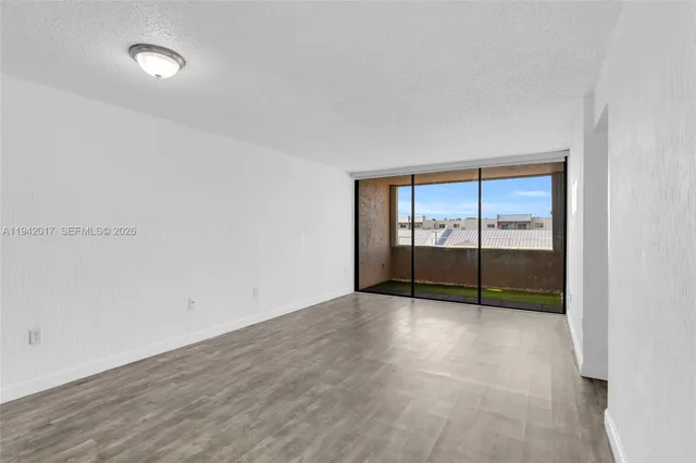wooden floor in an empty room with a sliding door