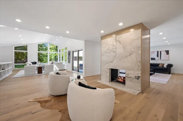a living room with fireplace furniture and a flat screen tv