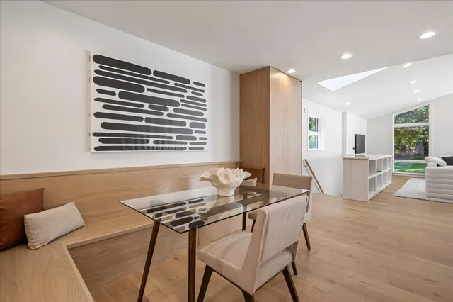 a dining room with furniture and wooden floor