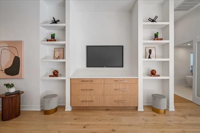 a hallway with a stove and a wooden floor