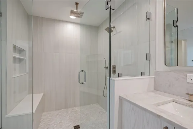 a bathroom with a shower and a sink