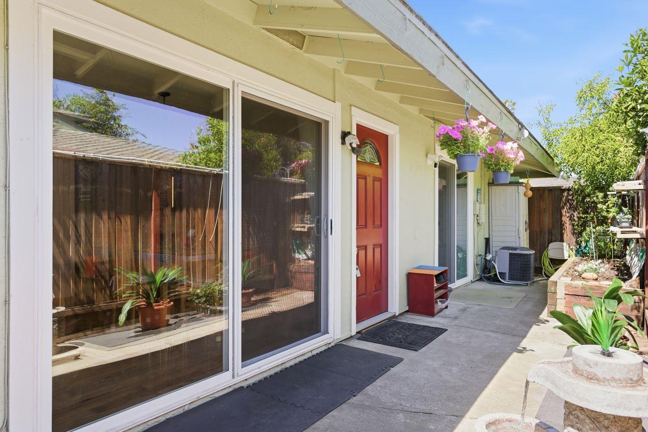 5561 Roundtree Common Fremont, CA 94538 - Photo 1 of 29 a view of a house with a potted plant and floor to ceiling window and potted plants