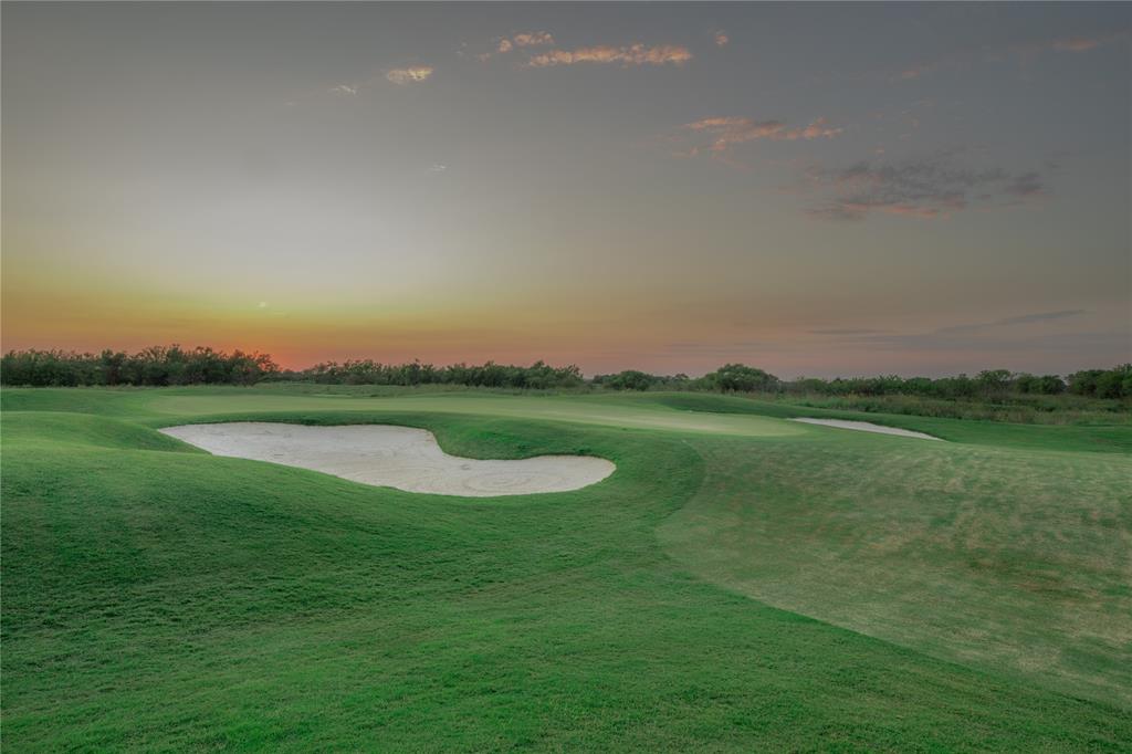 2715 Triumph Court Heath, TX 75126 - Photo 28 of 30 a view of a golf course with a lake