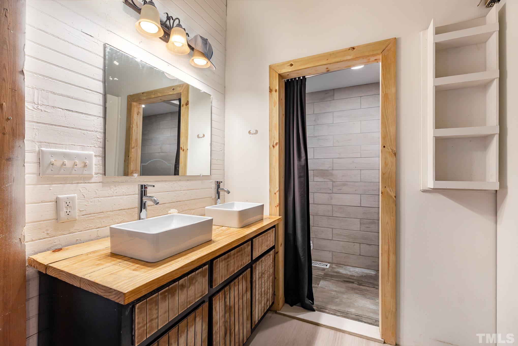 3716 Hayfield Road Wade, NC 28395 - Photo 11 of 24 a bathroom with a sink vanity granite and a mirror