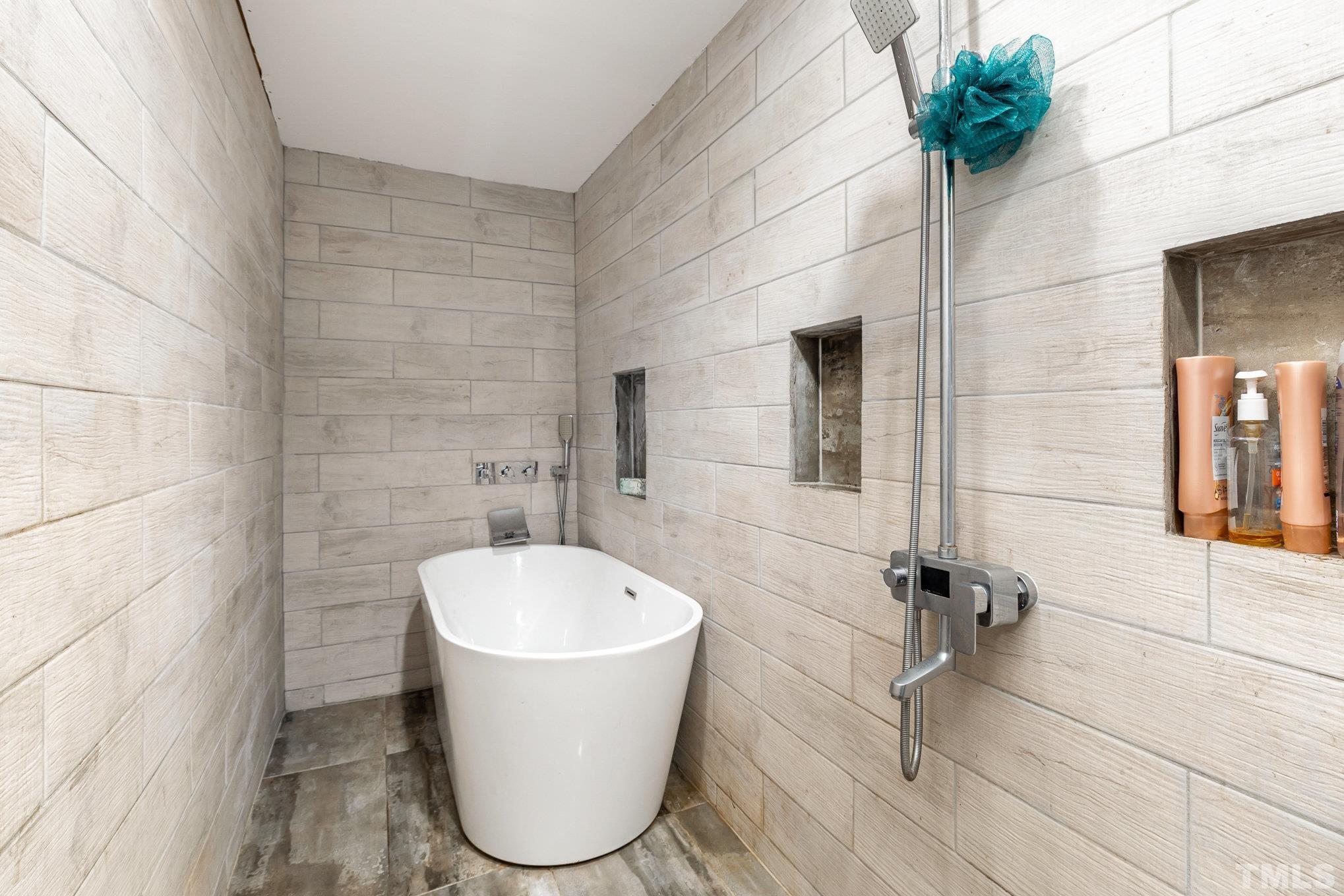 3716 Hayfield Road Wade, NC 28395 - Photo 12 of 24 a bathroom with a bathtub and shower