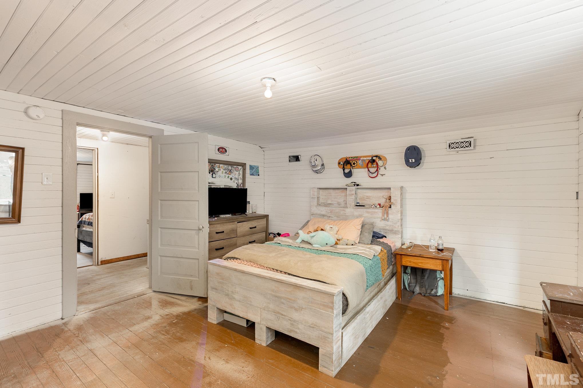 3716 Hayfield Road Wade, NC 28395 - Photo 15 of 24 a bedroom with a bed and a tv on table