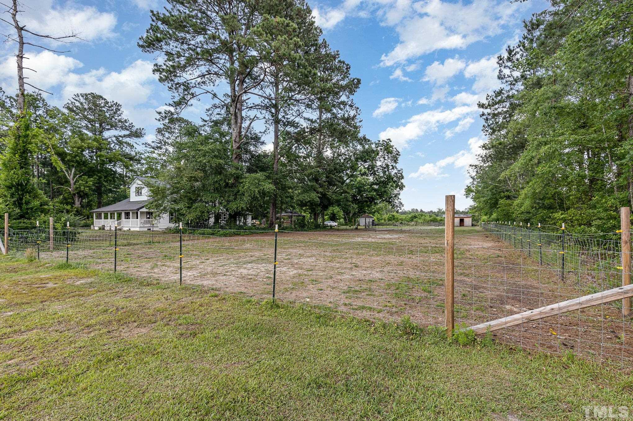 3716 Hayfield Road Wade, NC 28395 - Photo 17 of 24 a backyard of a house with lots of trees
