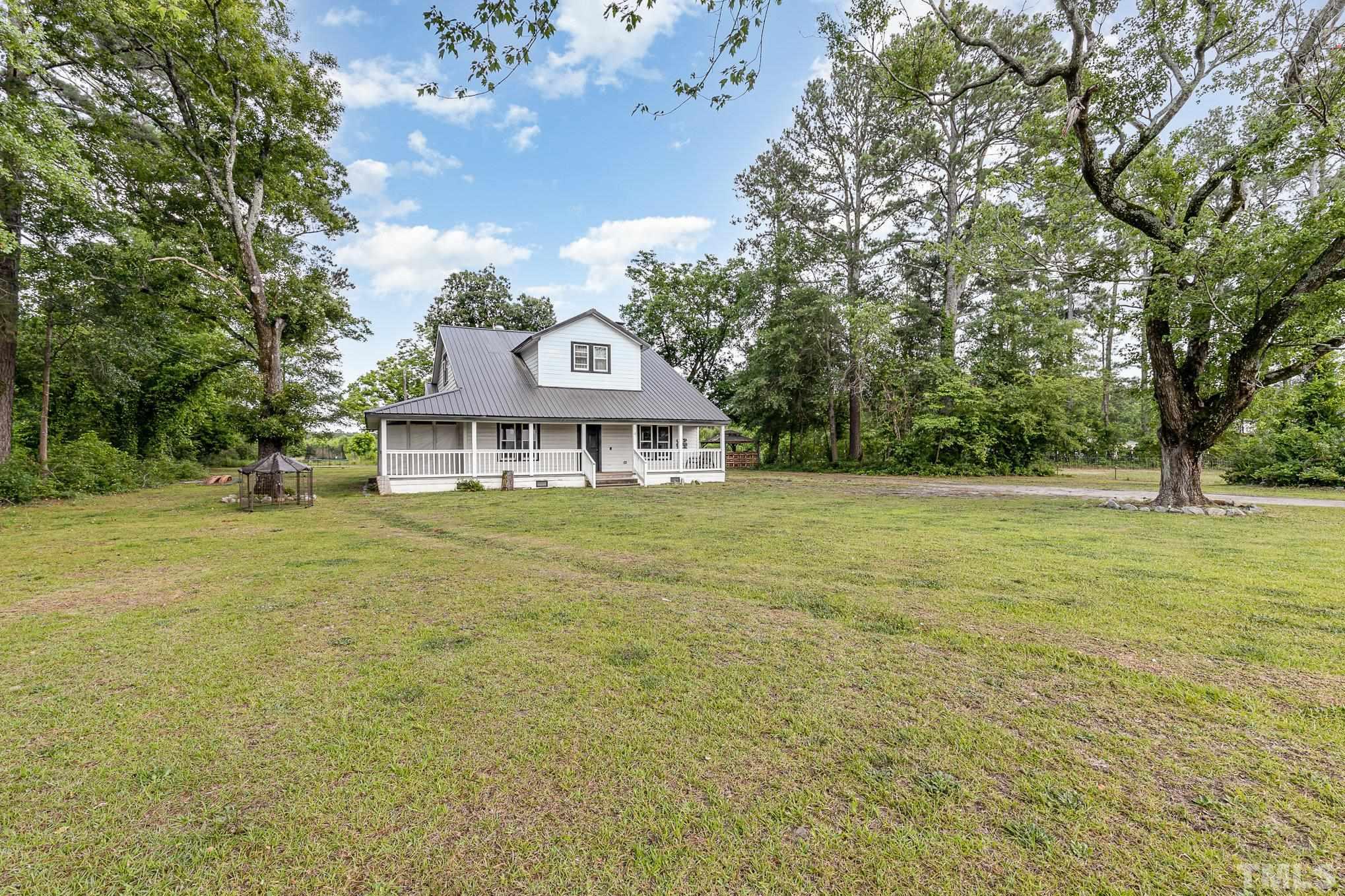 3716 Hayfield Road Wade, NC 28395 - Photo 2 of 24 a front view of a house with a garden