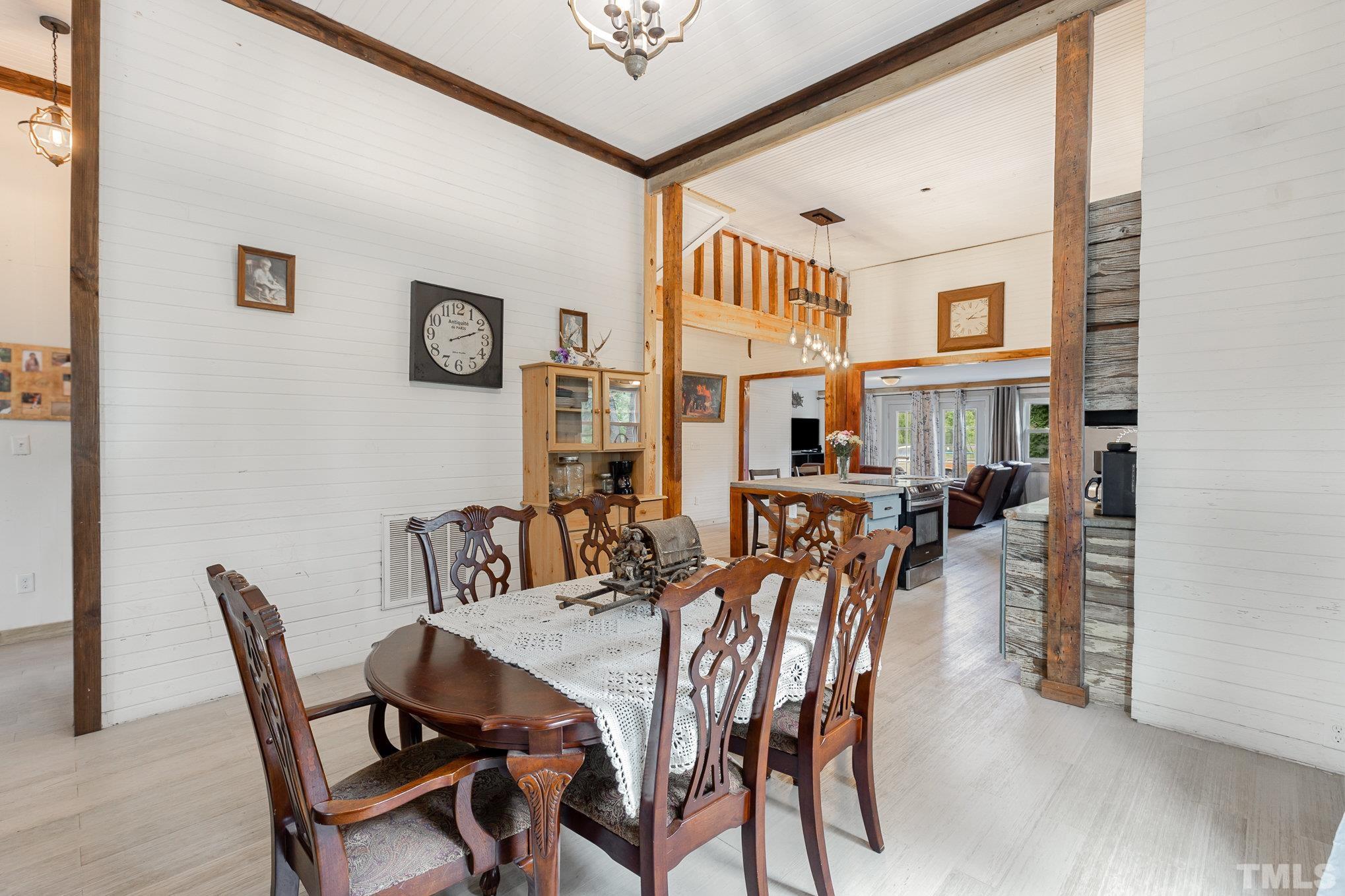 3716 Hayfield Road Wade, NC 28395 - Photo 6 of 24 a view of a dining room with furniture and a chandelier