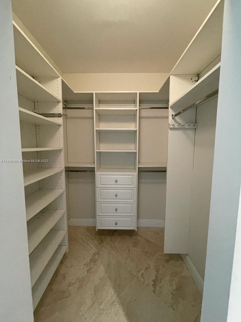 901 Brickell Key Boulevard, Unit 1005 Miami, FL 33131 - Photo 13 of 41 a view of walk in closet with empty racks