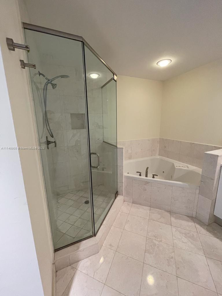 901 Brickell Key Boulevard, Unit 1005 Miami, FL 33131 - Photo 15 of 41 a bathroom with a bathtub and a shower