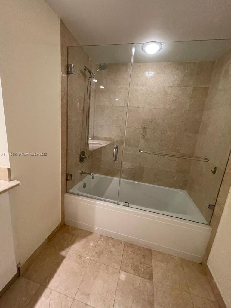 901 Brickell Key Boulevard, Unit 1005 Miami, FL 33131 - Photo 18 of 41 a bathroom with a bathtub and a shower