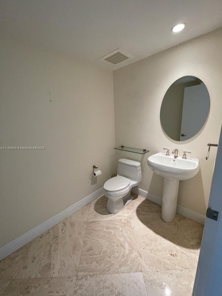 901 Brickell Key Boulevard, Unit 1005 Miami, FL 33131 - Photo 19 of 41 a bathroom with a sink toilet and mirror