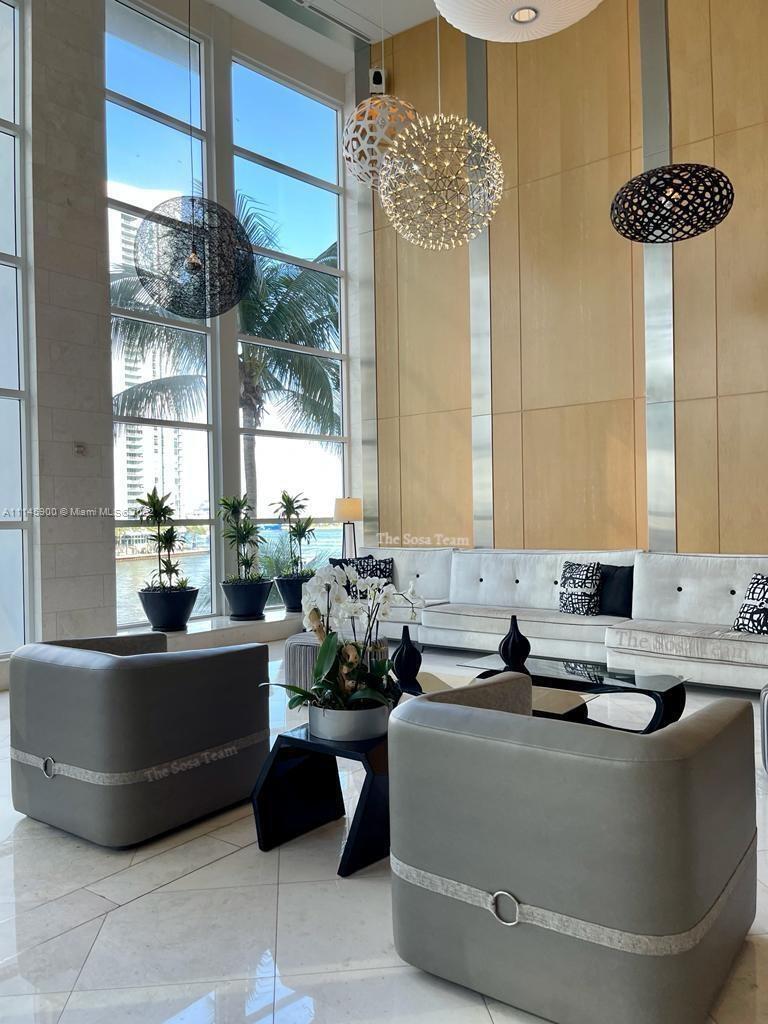 901 Brickell Key Boulevard, Unit 1005 Miami, FL 33131 - Photo 22 of 41 a living room with furniture and a large window