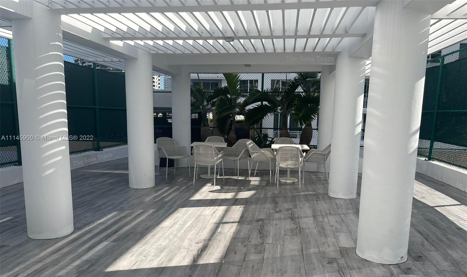 901 Brickell Key Boulevard, Unit 1005 Miami, FL 33131 - Photo 29 of 41 a living room with furniture a flat screen tv and large window