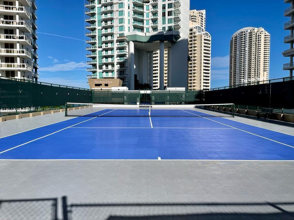 901 Brickell Key Boulevard, Unit 1005 Miami, FL 33131 - Photo 30 of 41 a swimming pool with outdoor seating and yard