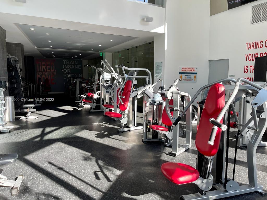 901 Brickell Key Boulevard, Unit 1005 Miami, FL 33131 - Photo 34 of 41 a view of a room with gym equipment