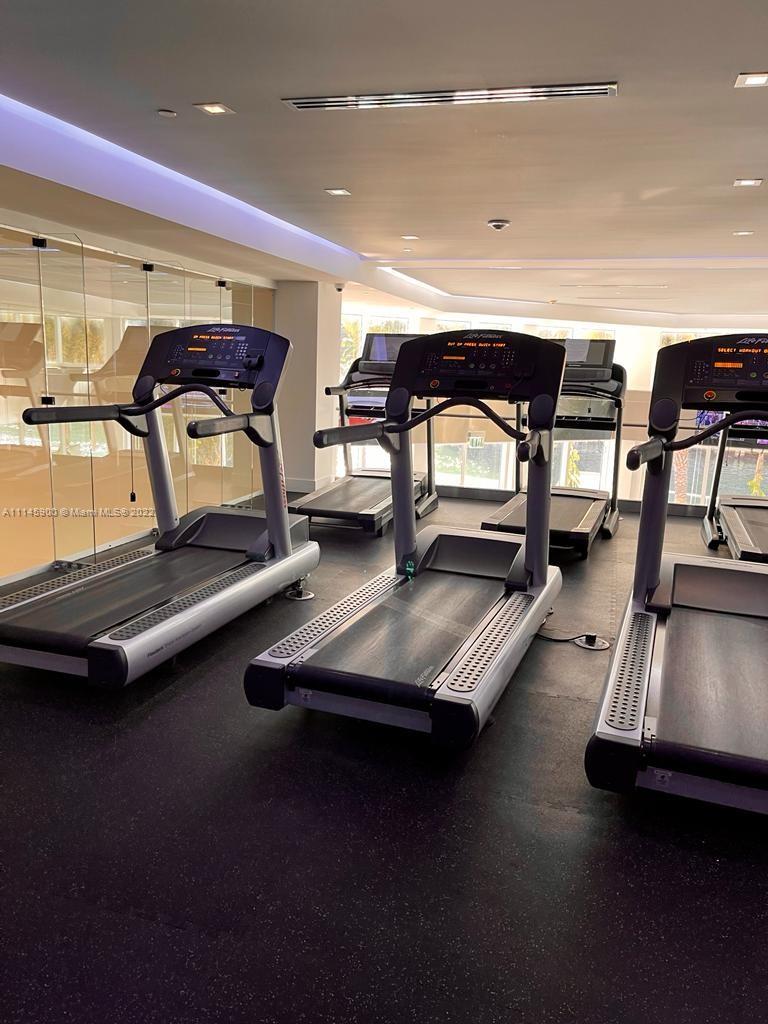 901 Brickell Key Boulevard, Unit 1005 Miami, FL 33131 - Photo 40 of 41 a view of a room with gym equipment