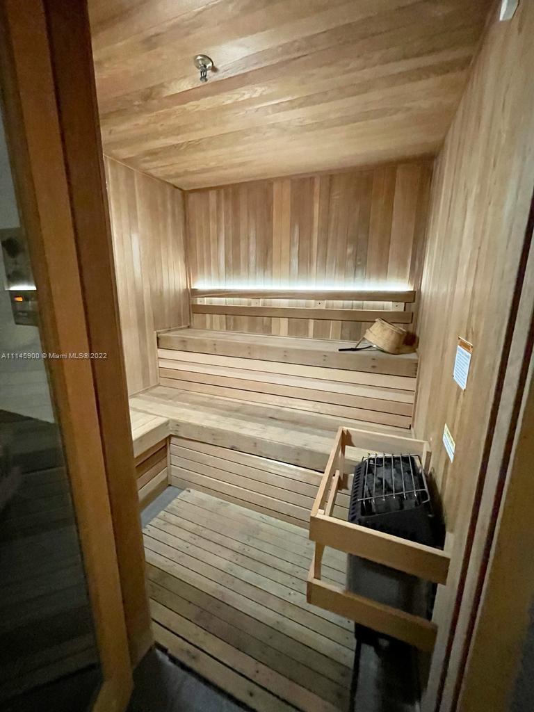 901 Brickell Key Boulevard, Unit 1005 Miami, FL 33131 - Photo 41 of 41 a kitchen with wooden cabinets and a stove