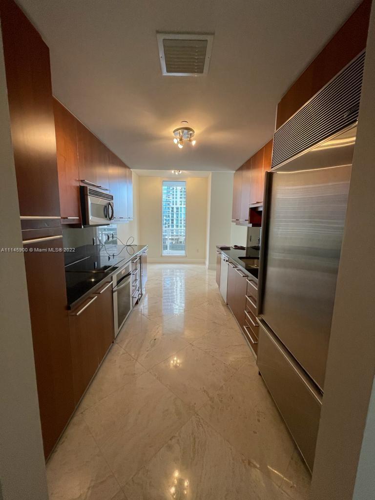 901 Brickell Key Boulevard, Unit 1005 Miami, FL 33131 - Photo 9 of 41 a kitchen with stainless steel appliances granite countertop a refrigerator and a stove