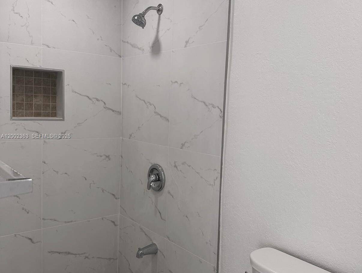 8545 Harding Avenue, Unit 5 Miami Beach, FL 33141 - Photo 8 of 10 a bathroom with a toilet