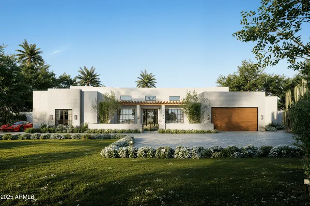 a front view of a house with a garden and yard