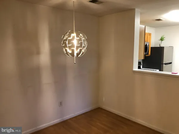 a view of a room with a hardwood and a ceiling fan