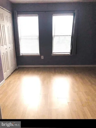 a bedroom with a bed and a dresser with mirror