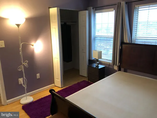 a bed sitting in a bedroom next to a window
