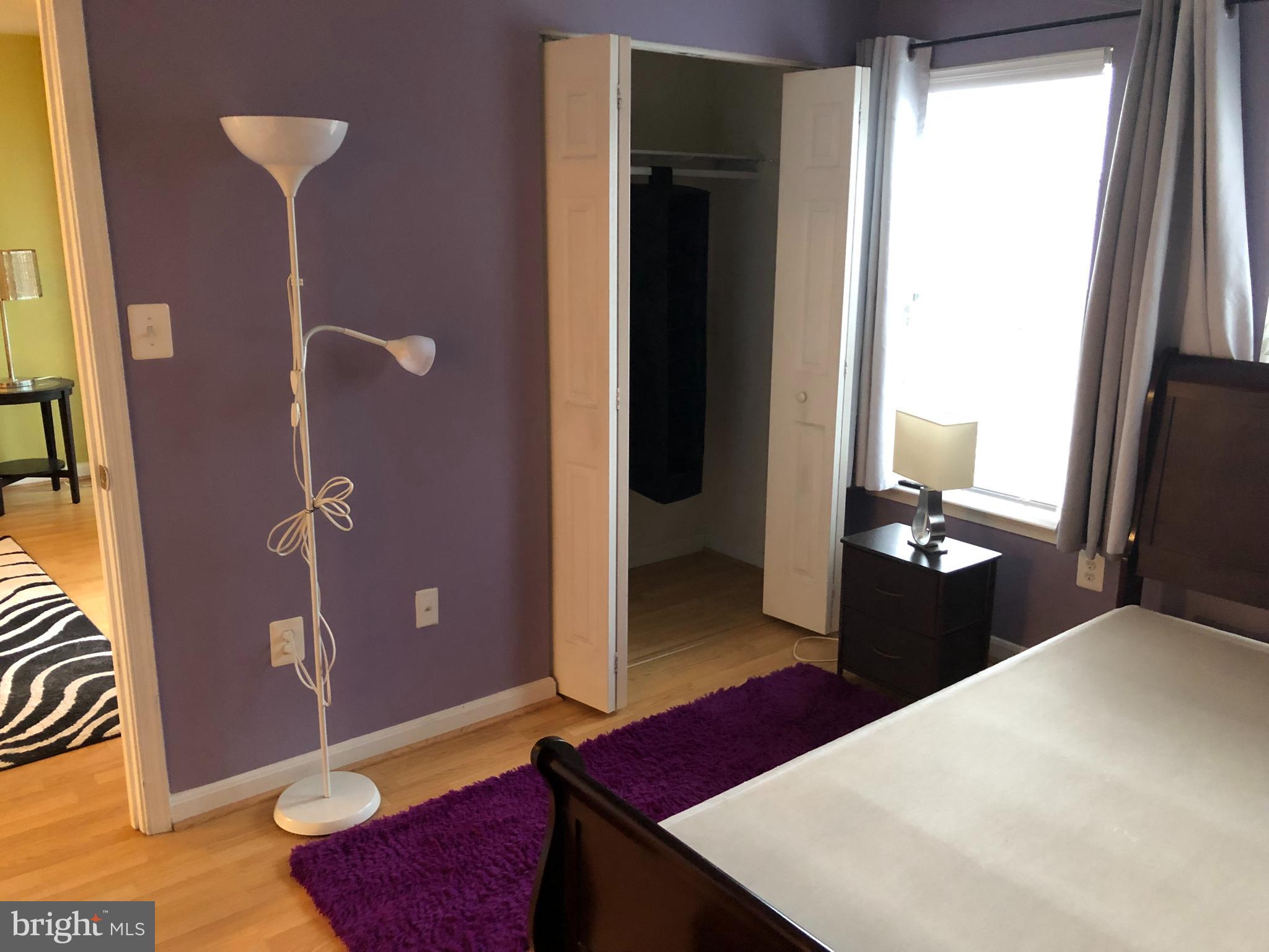1055 Gardenview Loop, Unit 304 Woodbridge, VA 22191 - Photo 23 of 70 a bedroom with a bed and a dresser with mirror
