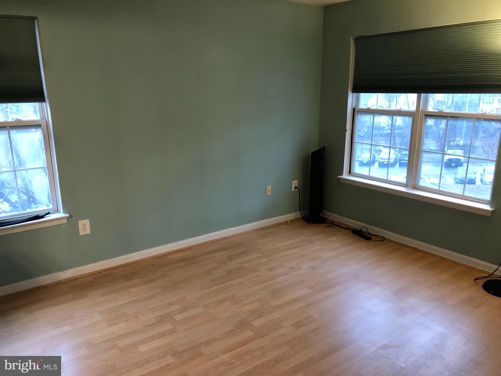 1055 Gardenview Loop, Unit 304 Woodbridge, VA 22191 - Photo 28 of 70 an empty room with wooden floor and windows