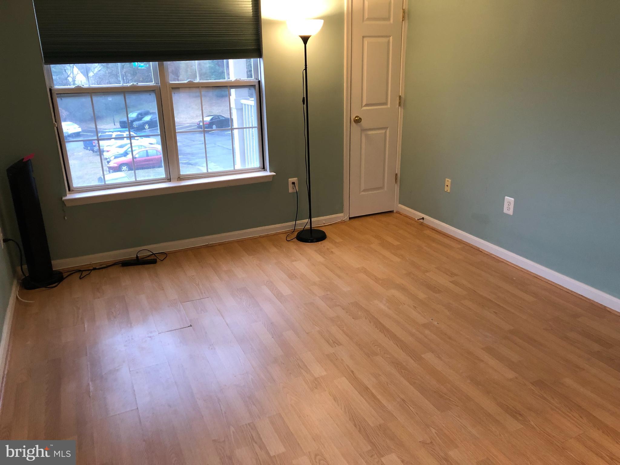 1055 Gardenview Loop, Unit 304 Woodbridge, VA 22191 - Photo 31 of 70 an empty room with wooden floor and windows