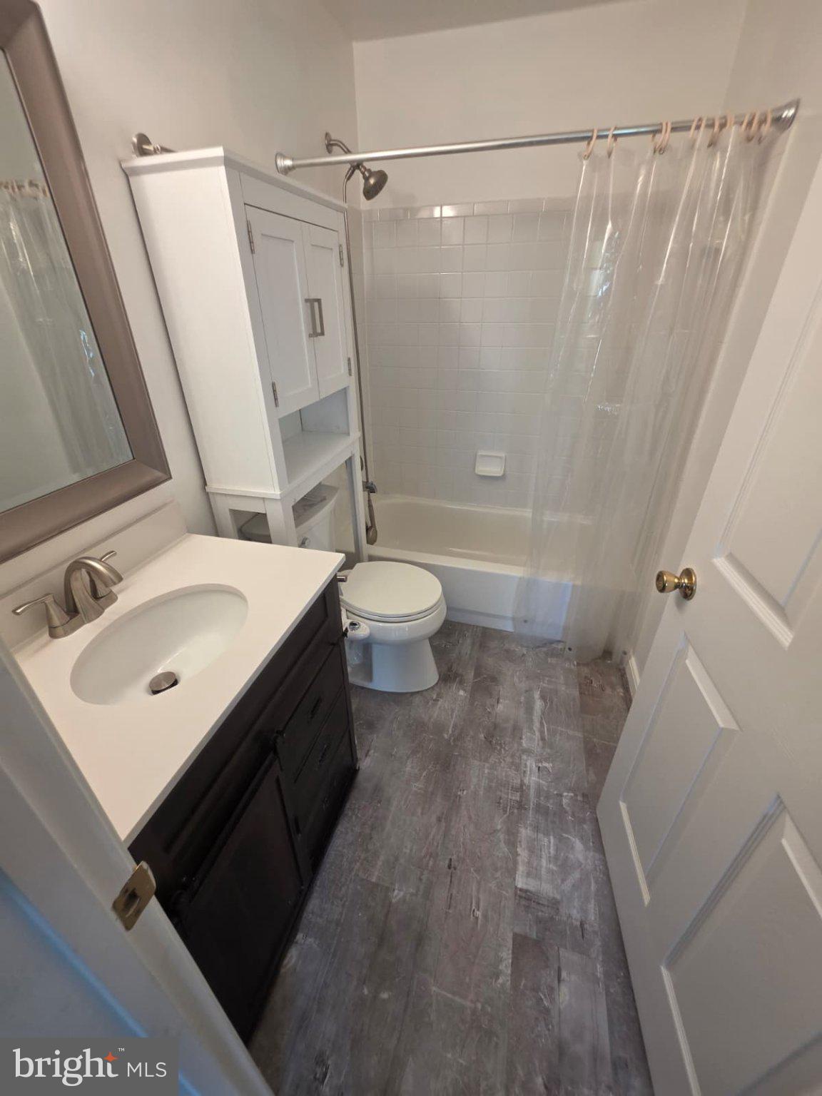 1055 Gardenview Loop, Unit 304 Woodbridge, VA 22191 - Photo 48 of 70 a bathroom with a sink a toilet a mirror and shower
