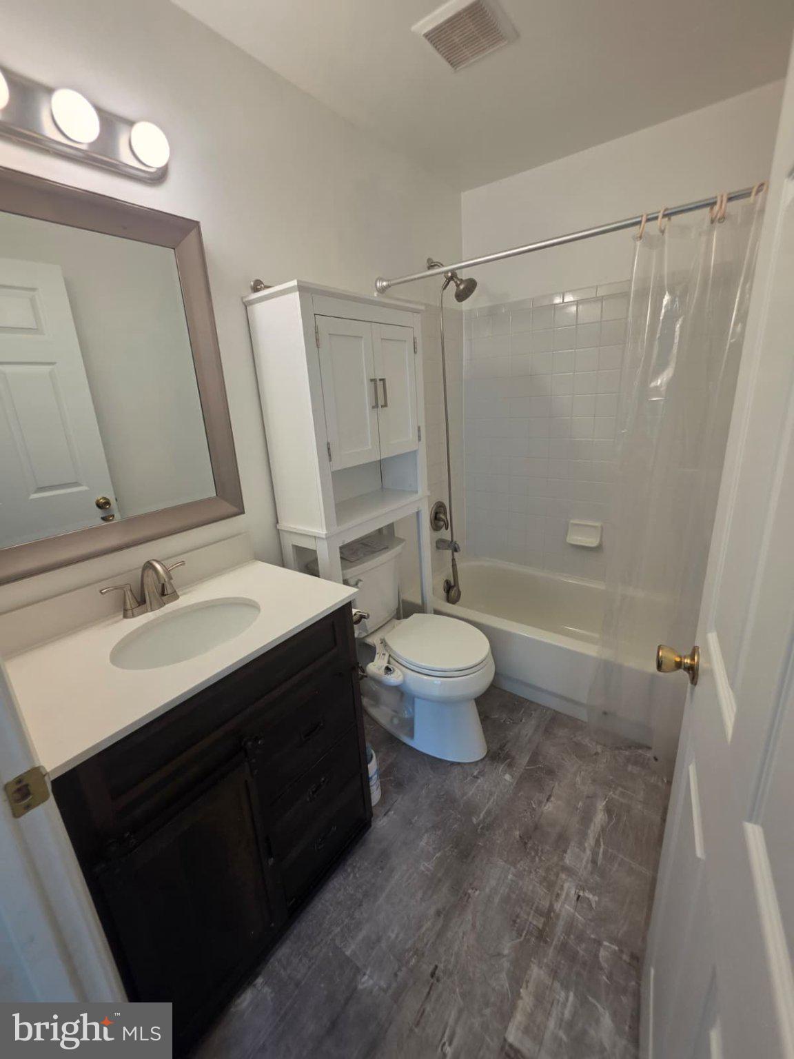 1055 Gardenview Loop, Unit 304 Woodbridge, VA 22191 - Photo 49 of 70 a bathroom with a sink a toilet a mirror and shower