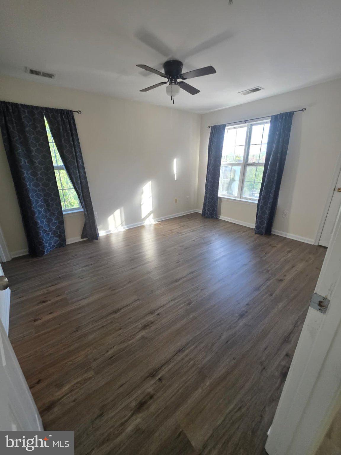 1055 Gardenview Loop, Unit 304 Woodbridge, VA 22191 - Photo 50 of 70 a view of an empty room with wooden floor and a window