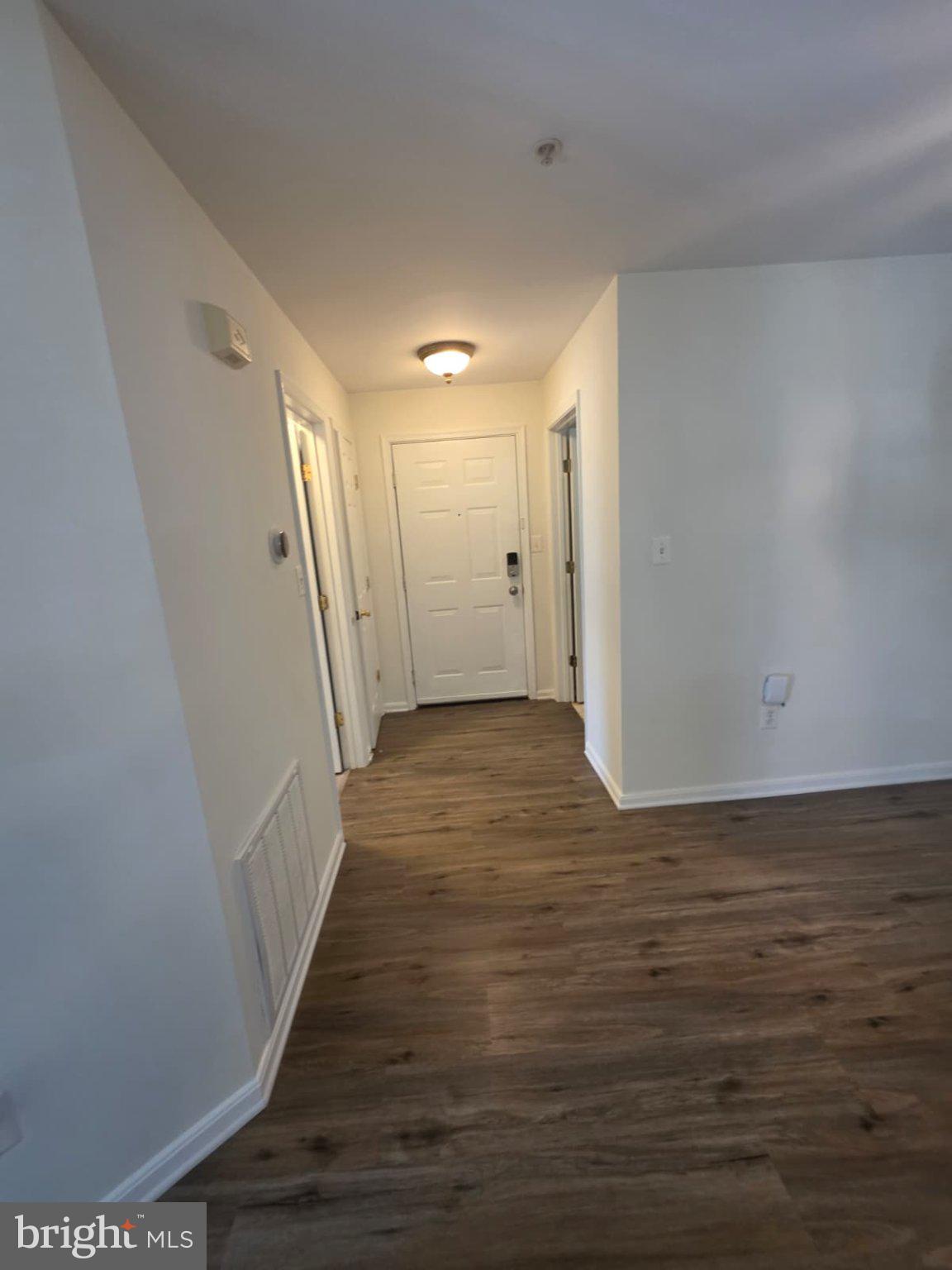 1055 Gardenview Loop, Unit 304 Woodbridge, VA 22191 - Photo 57 of 70 a view of a hallway with wooden floor