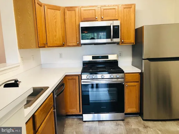 a kitchen with a refrigerator stove and microwave