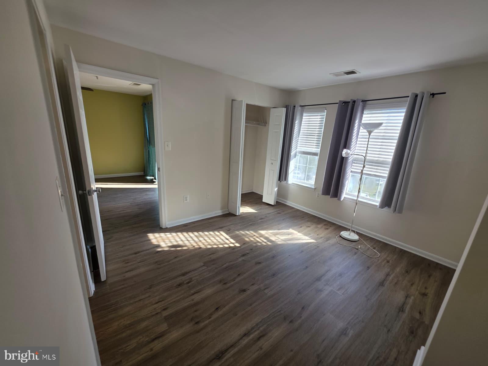 1055 Gardenview Loop, Unit 304 Woodbridge, VA 22191 - Photo 63 of 70 wooden floor in an empty room with a window