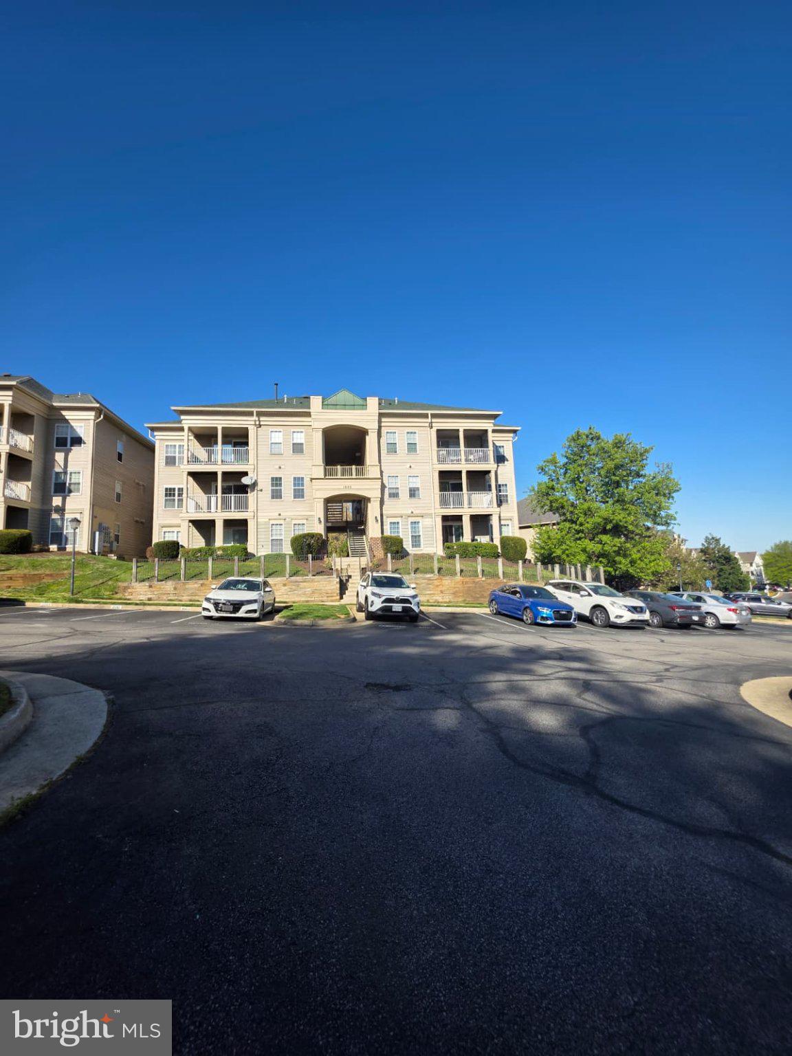 1055 Gardenview Loop, Unit 304 Woodbridge, VA 22191 - Photo 70 of 70 Charming apartment complex under blue skies.