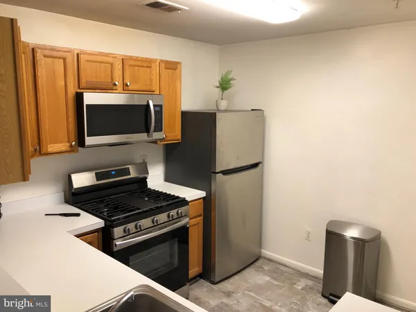 a kitchen with a refrigerator stove and microwave