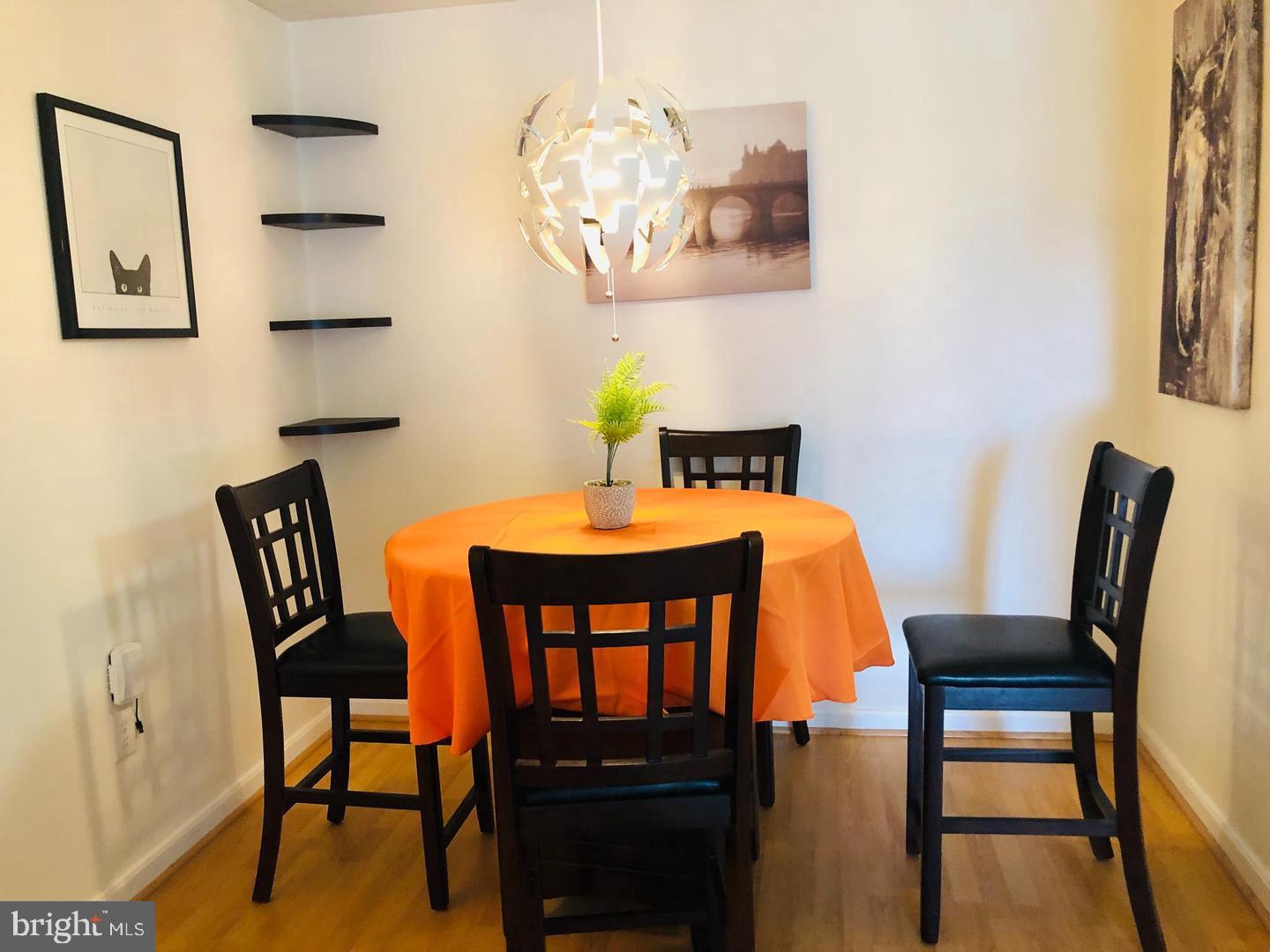 1055 Gardenview Loop, Unit 304 Woodbridge, VA 22191 - Photo 10 of 70 a view of a dining room with furniture and wooden floor