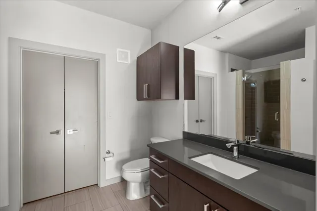 a bathroom with a sink a toilet and mirror