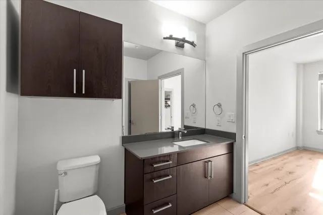 a kitchen with sink a microwave and cabinets